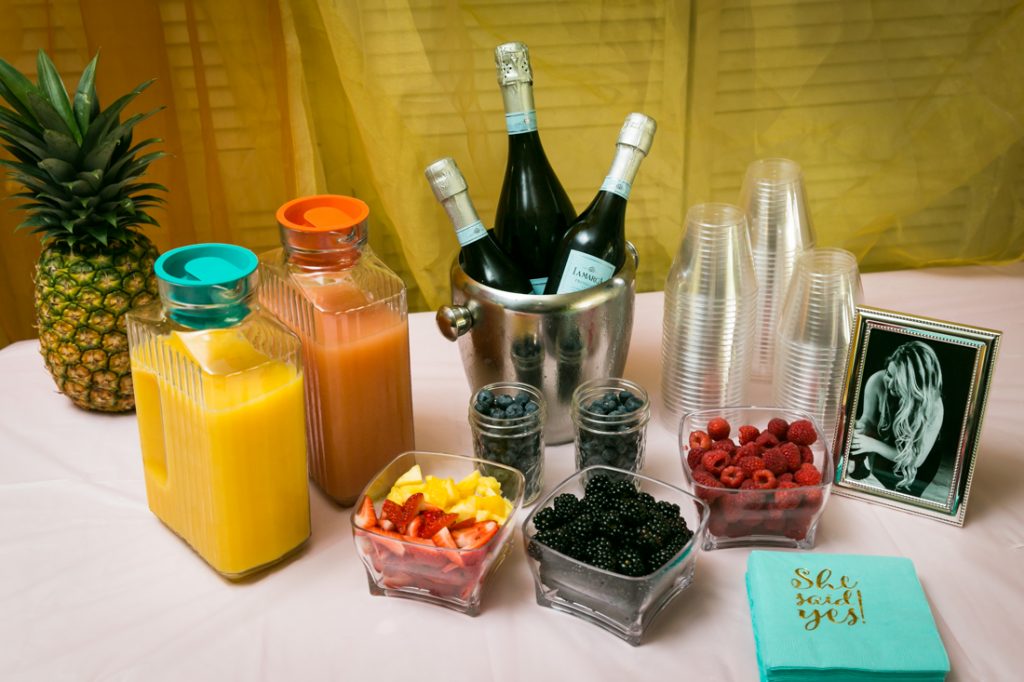 Champagne bar with glasses, fruit, and bottles