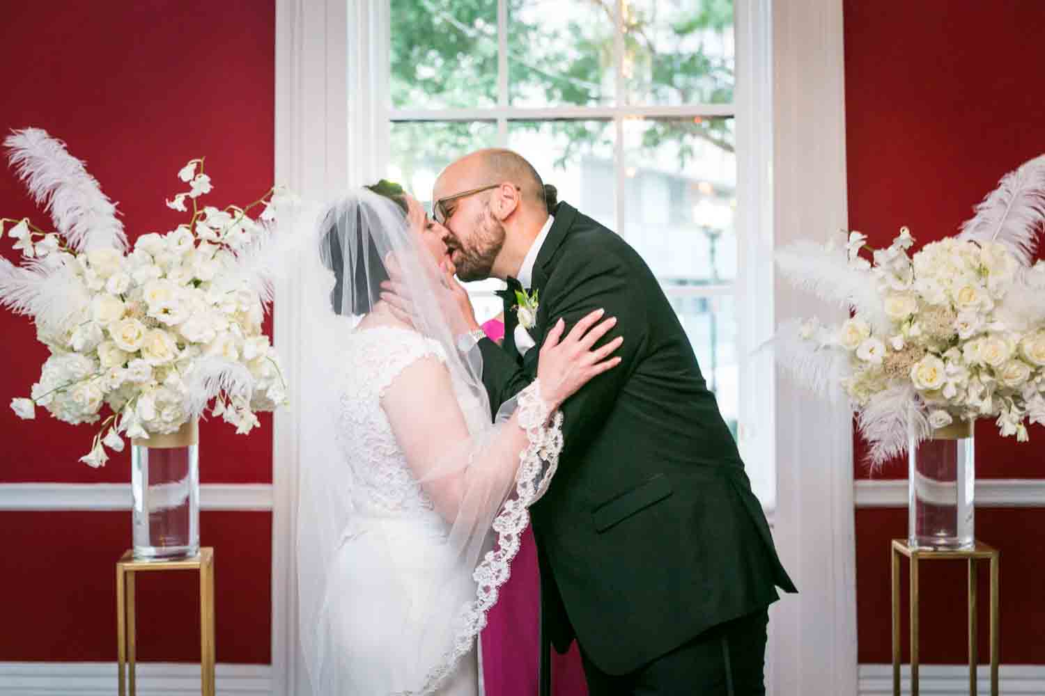 India House wedding photos of bride and groom kissing at end of ceremony
