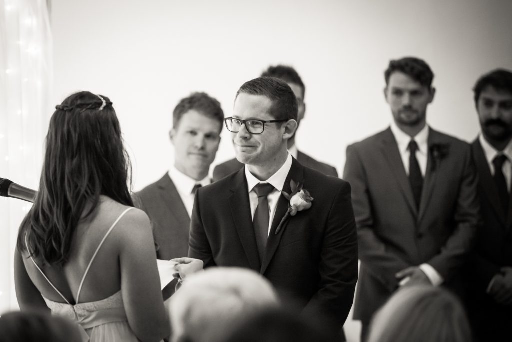 Black and white photo of groom during Bathhouse Studios wedding ceremony