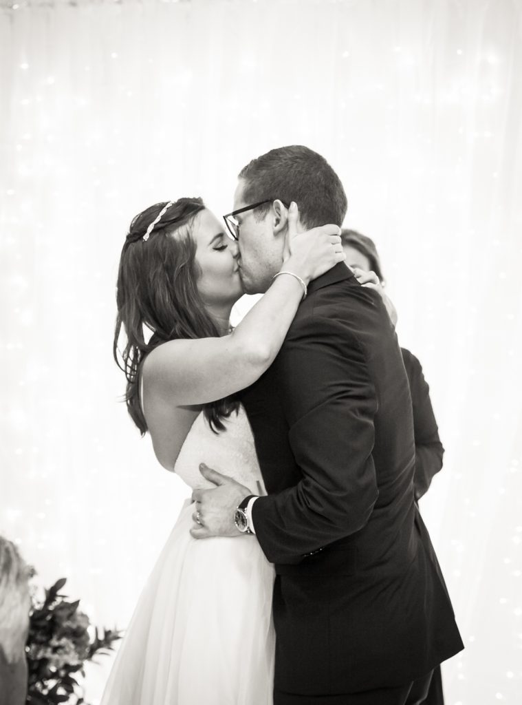 Black and white photo of bride and groom kissing after Bathhouse Studios wedding ceremony