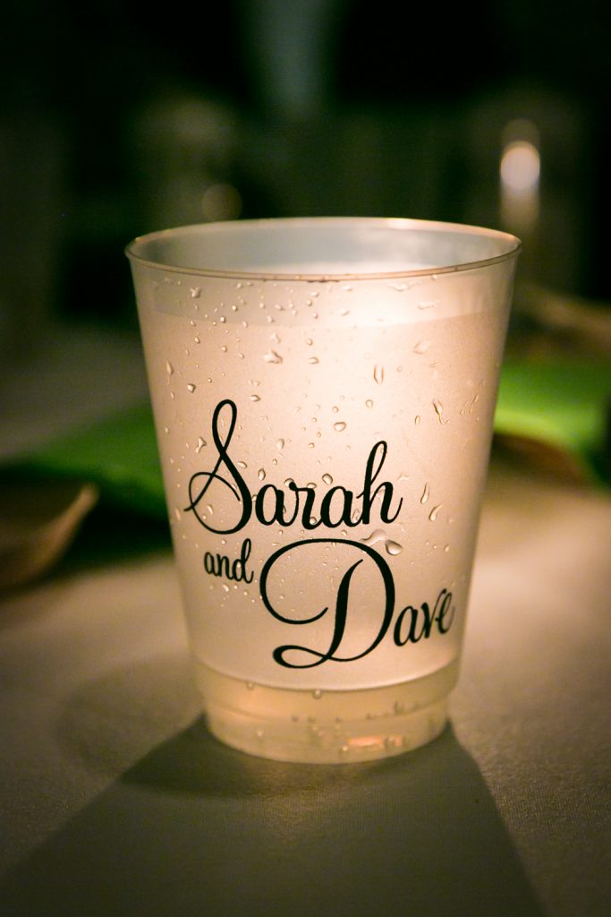 Glowing cup with the words 'Sarah and Dave' on it