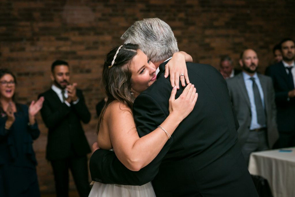 Bride hugging father at Bathhouse Studios wedding reception