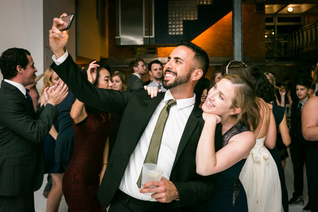 Man and woman taking selfie on dance floor at Bathhouse Studios wedding