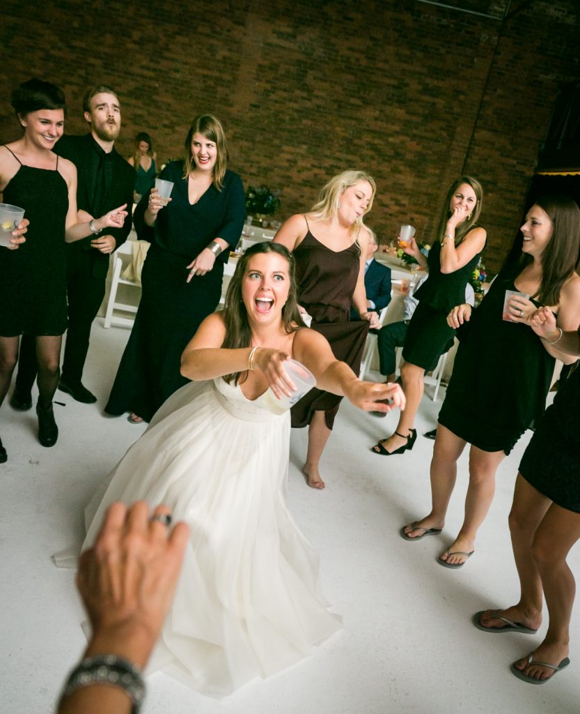 Bride pointing at guests on the dance floor