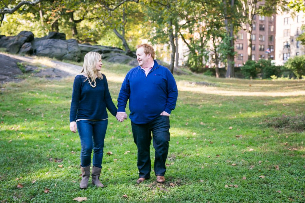 Central Park family photos couple walking across grass