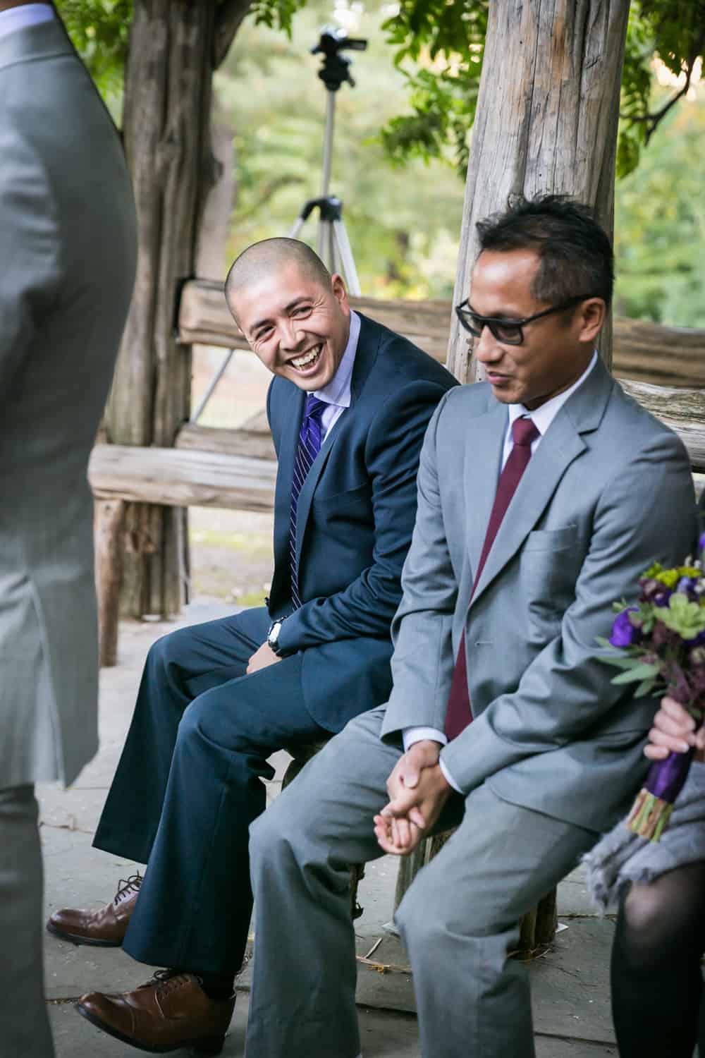 Two male guests laughing in Cop Cot wedding