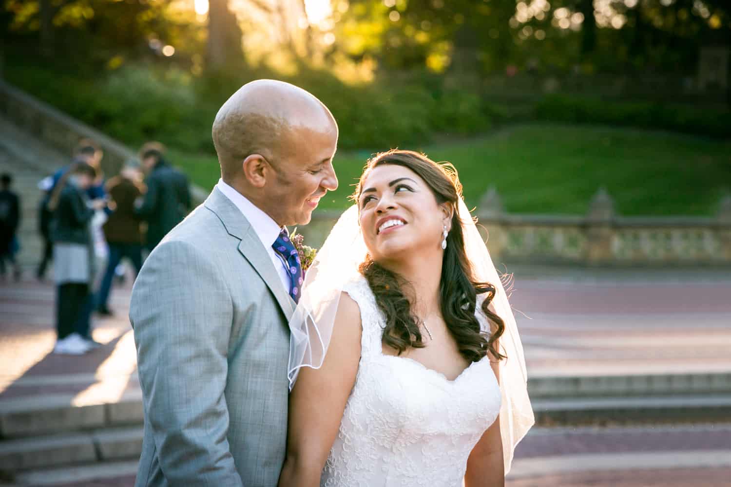 Bride and groom smiling at Bethesda Fountain in Central Park