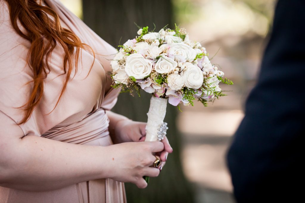 Close up of bride holding flower bouquet
