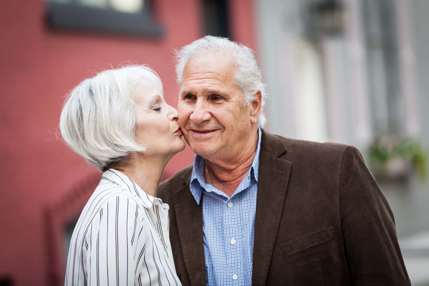 Older woman kissing man on the cheek