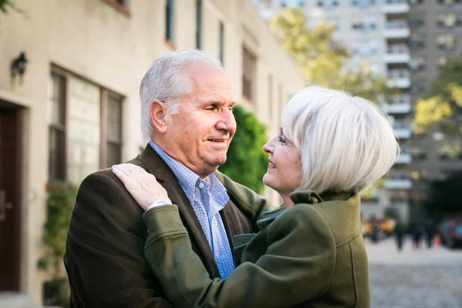 Photojournalistic portraits of older couple hugging in Washington Mews