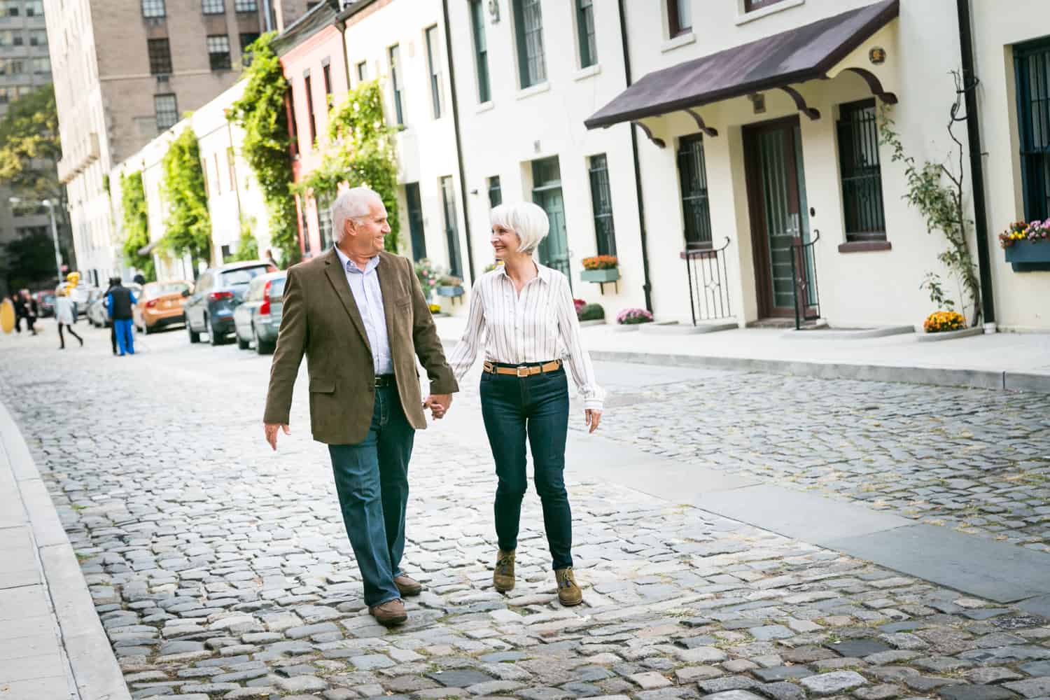 Photojournalistic portraits of older couple walking in Washington Mews