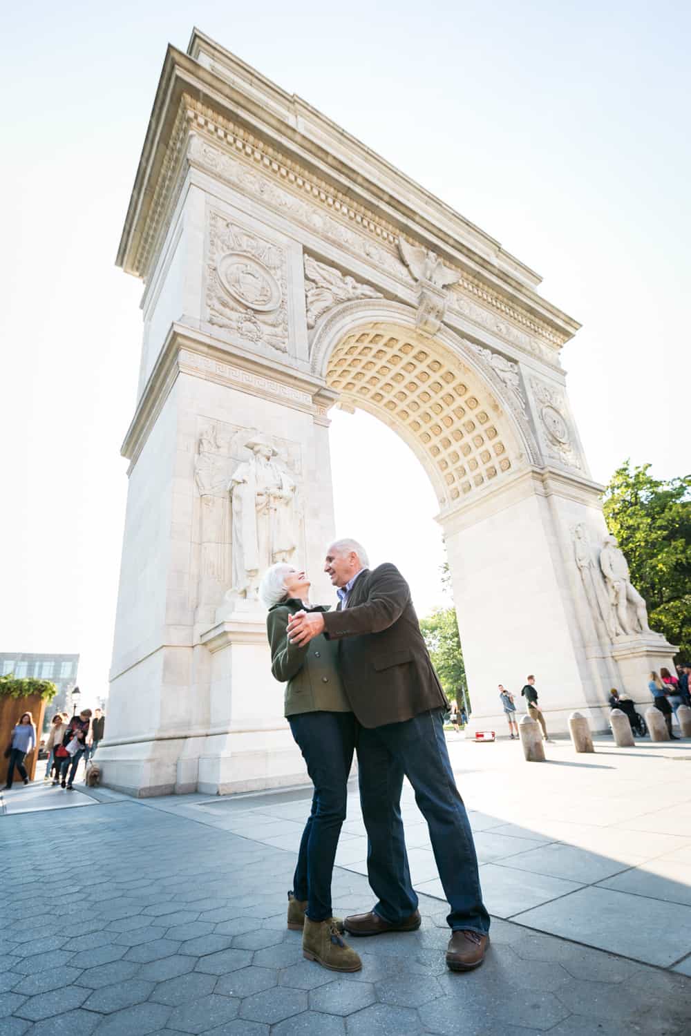 Photojournalistic portraits of older couple dancing in front of Washington Square Park arch