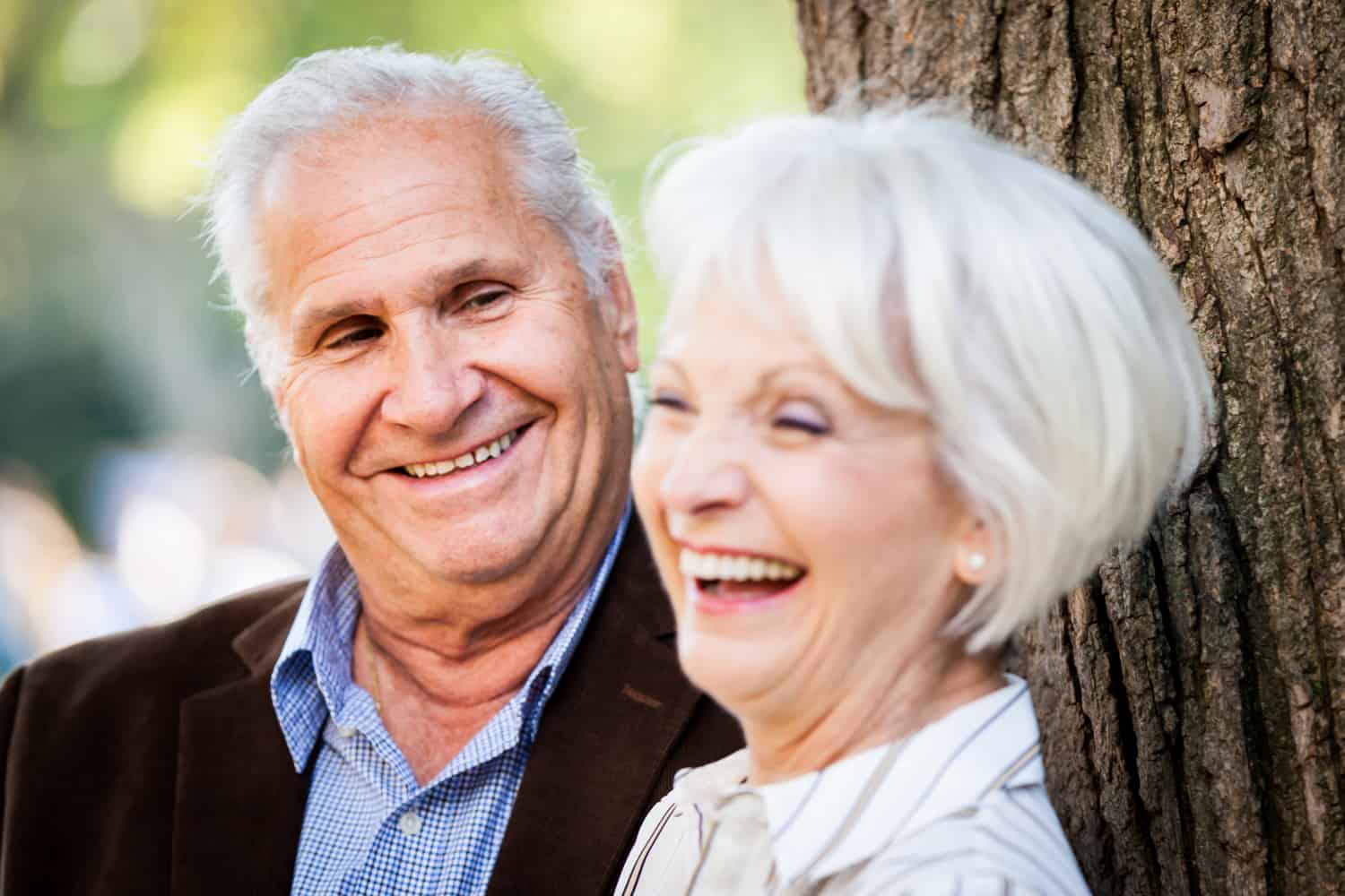 Older man looking at laughing older woman
