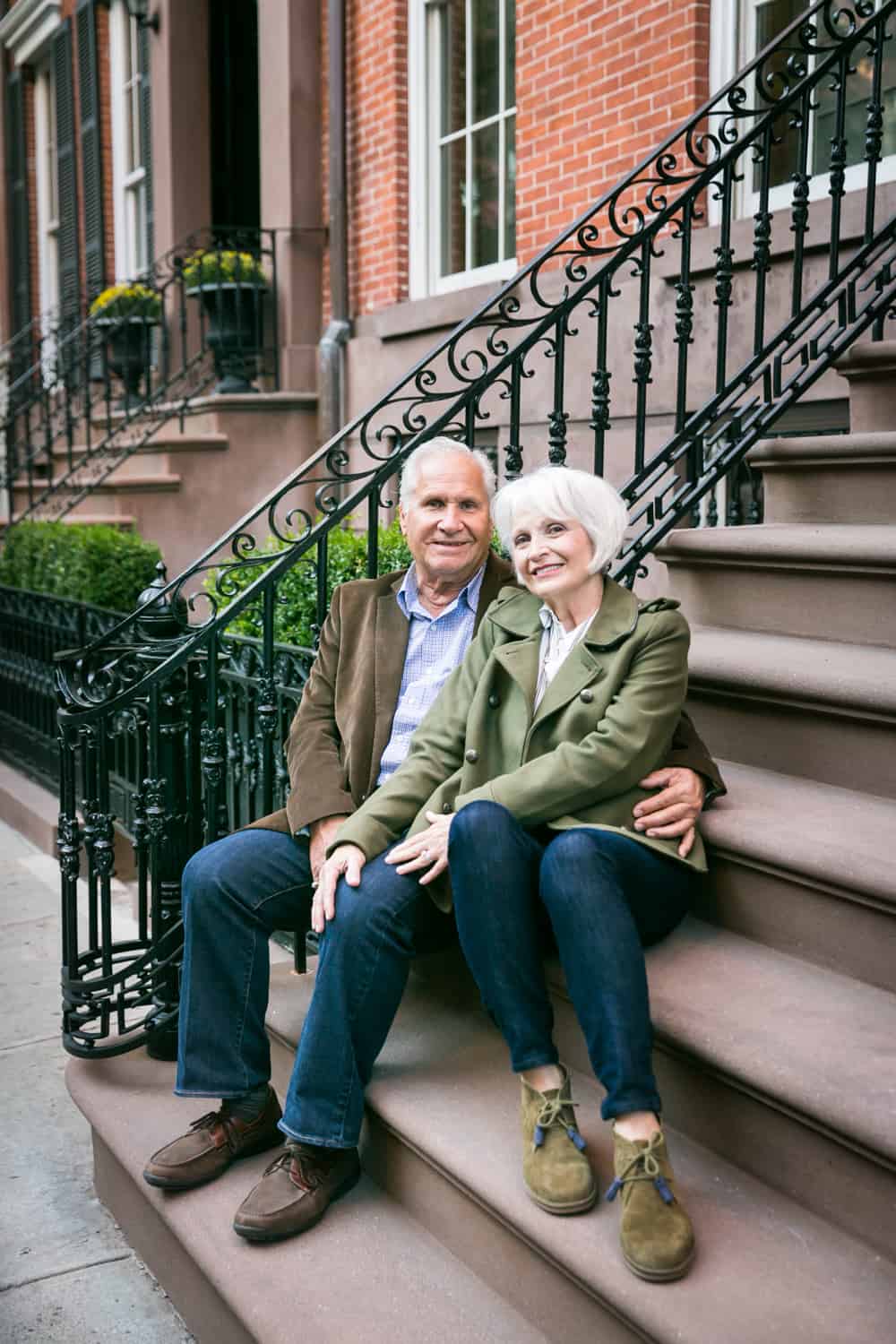 Older couple sitting on brownstone stairs