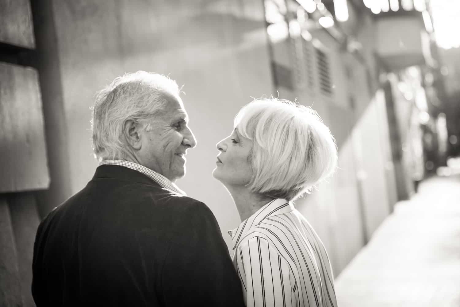 Black and white photo of older couple on sidewalk