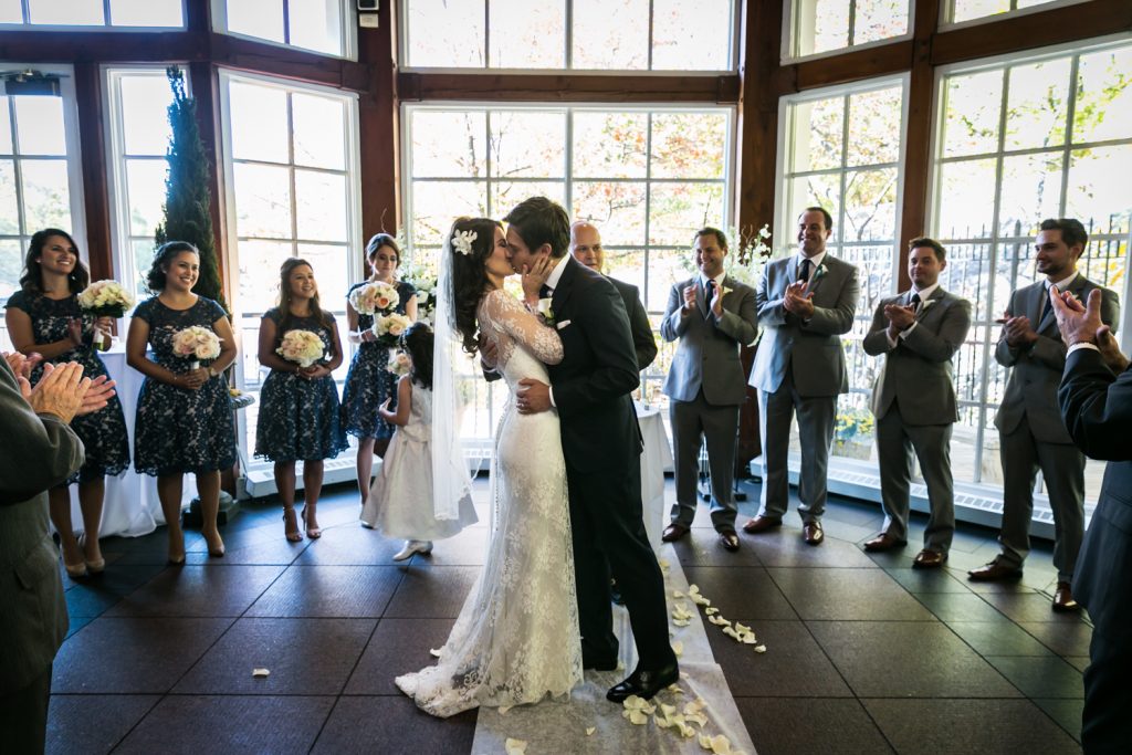 Bride and groom kissing after ceremony at a Loeb Boathouse wedding in Central Park