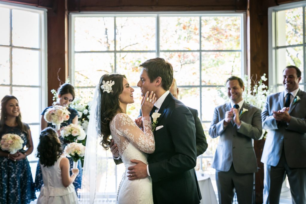 Bride and groom hugging during ceremony at a Loeb Boathouse wedding in Central Park