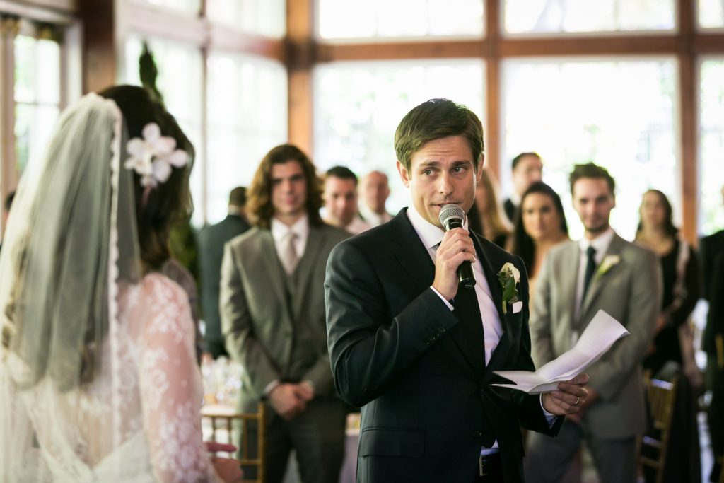 Groom looking at bride while giving speech