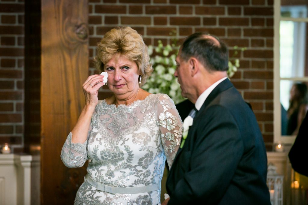 Mother of groom wiping away a tear
