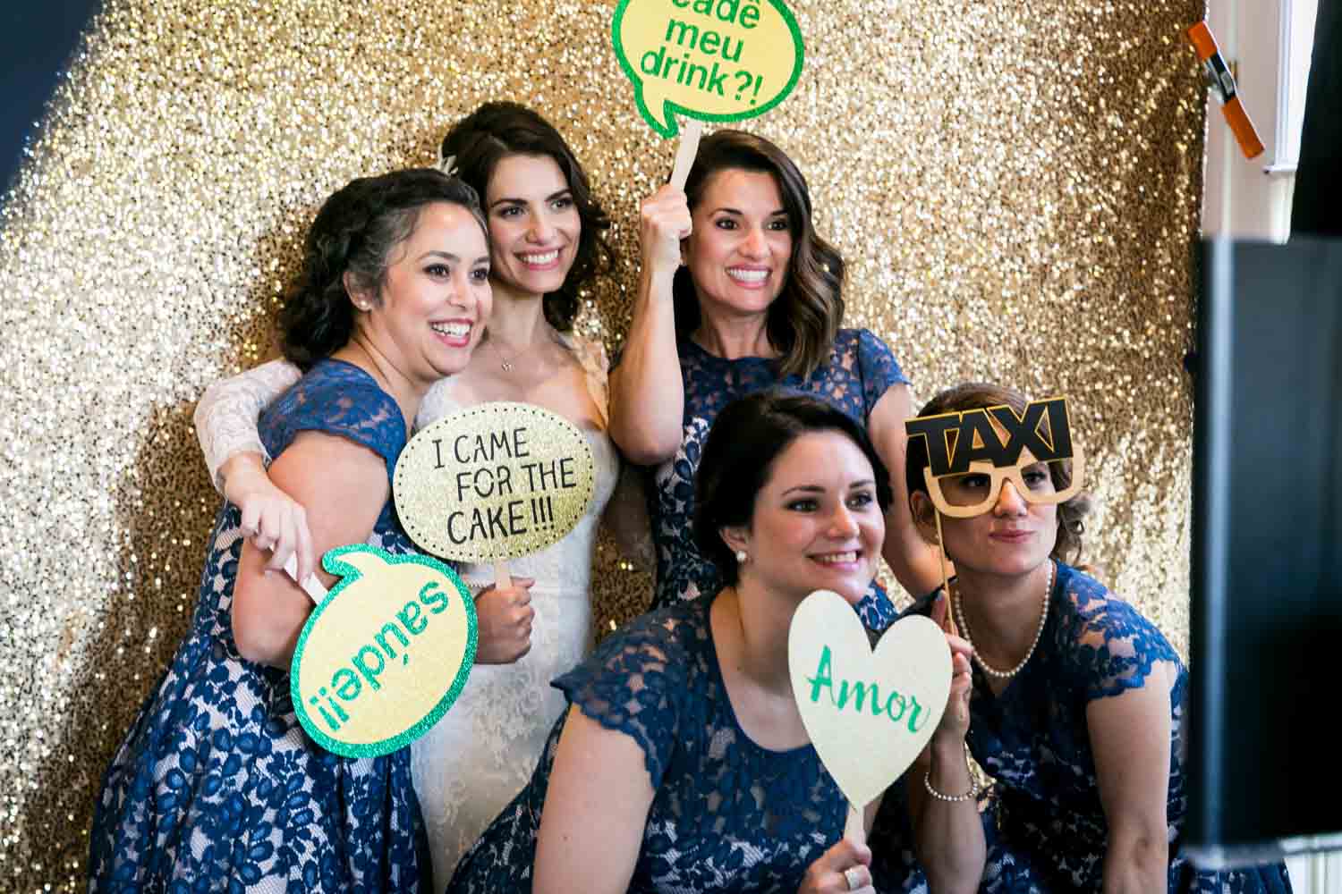 Bride and four female guests in a photobooth