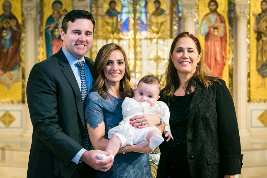 Portrait of parents, baby, and godmother after Greek orthodox baptism