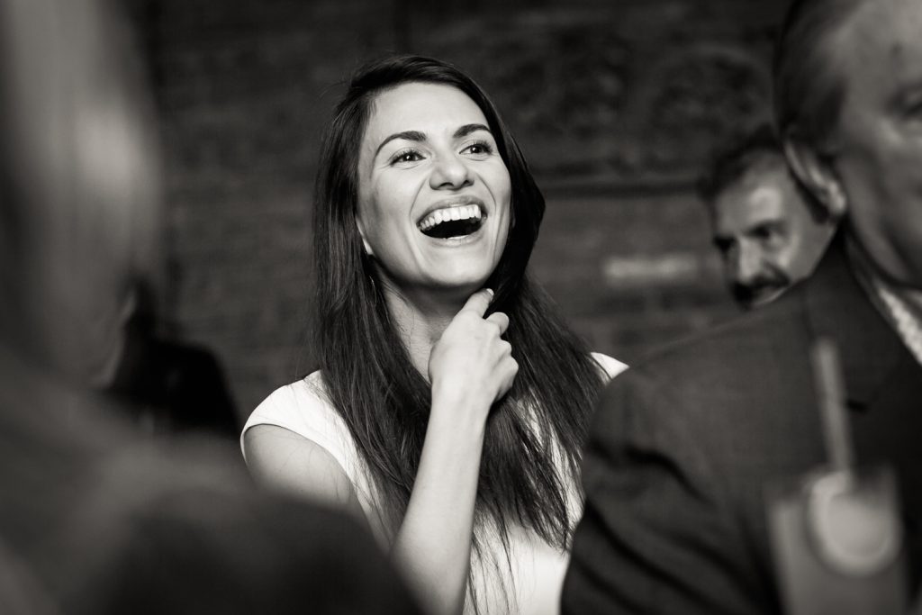 Black and white photo of woman laughing 