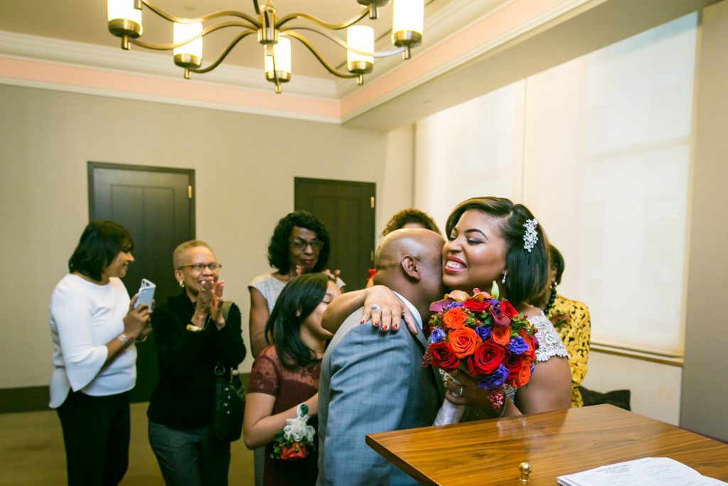 Bride hugging groom after City Hall wedding for an article on wedding website tips