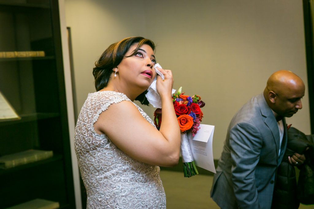Bride wiping away a tear after City Hall wedding