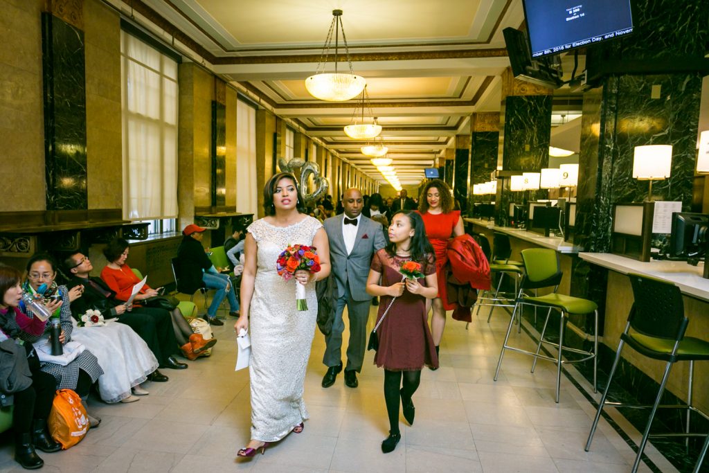Bride and guests walking out of City Clerk's Office after City Hall wedding