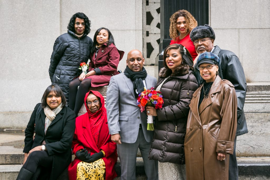 Portrait of bridal party wearing puffy coats after NYC City Hall wedding