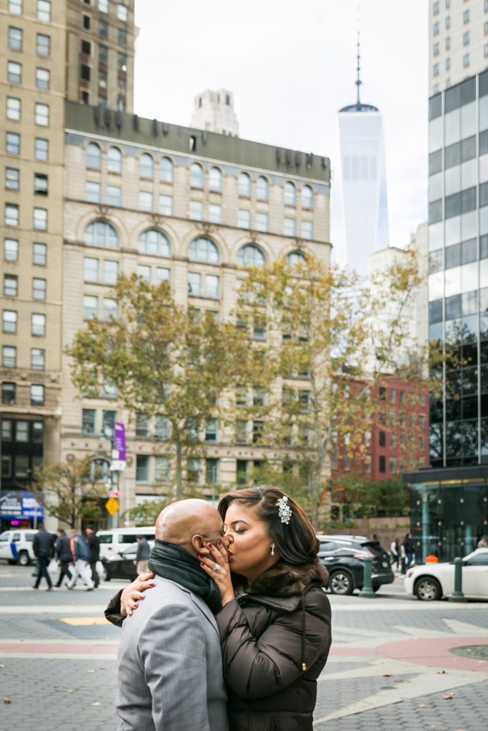Bride and groom kissing with Freedom Tower in the background for an article on wedding website tips