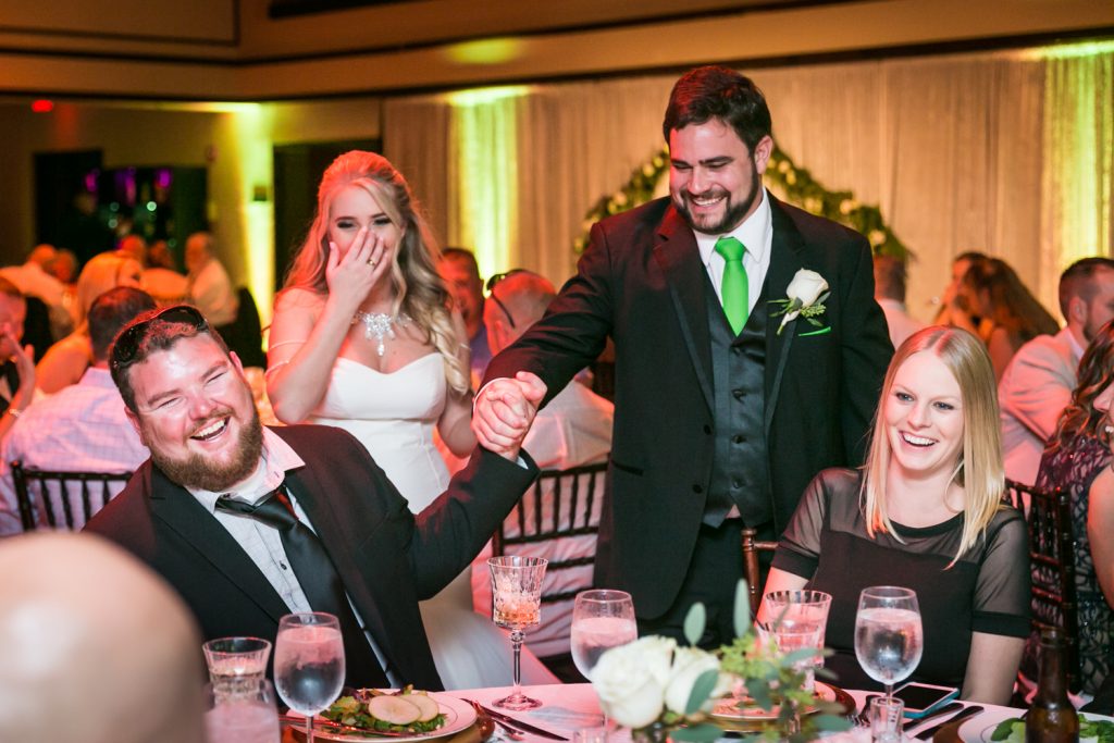 Bride and groom greeting guets for an article on how DJ lighting affects your wedding photos