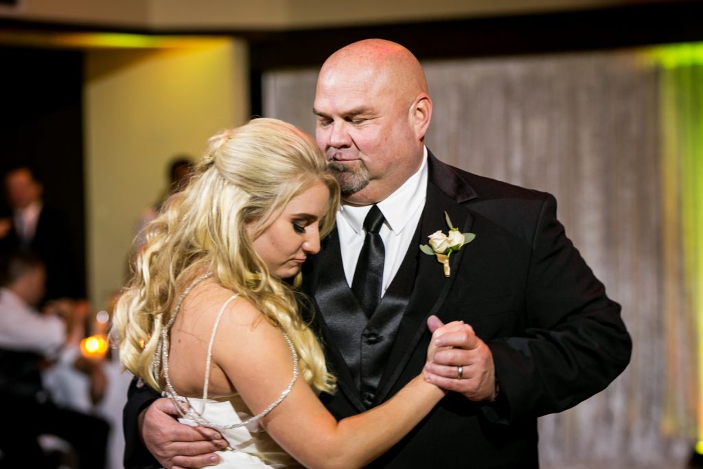 Bride and father dancing for an article on how DJ lighting affects your wedding photos