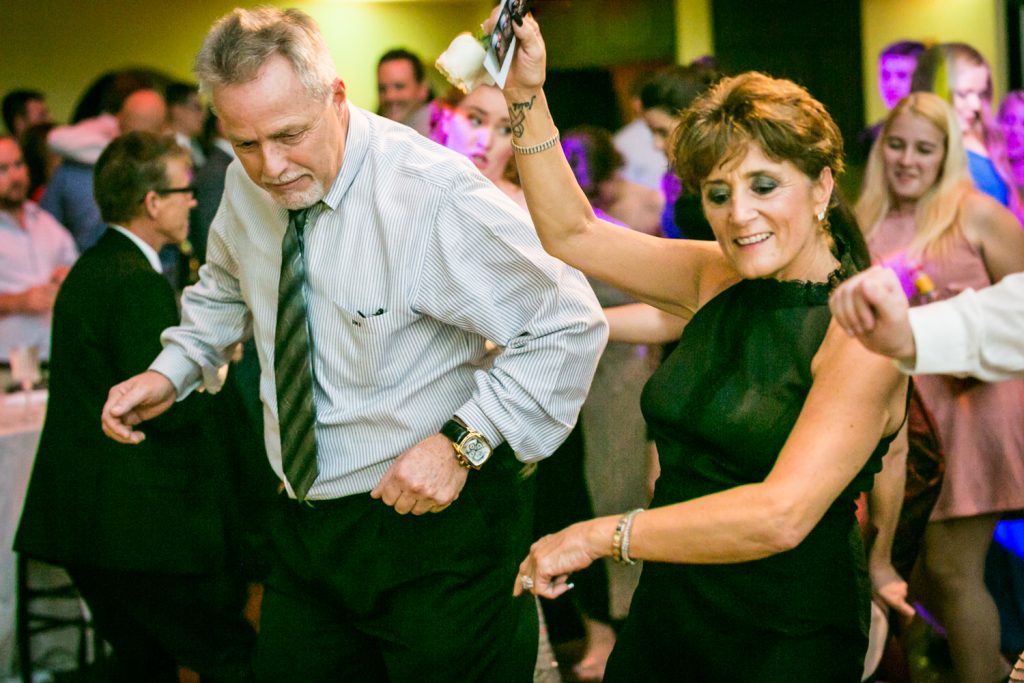 Guests dancing at a West Palm Beach wedding reception for an article on how DJ lighting affects your wedding photos