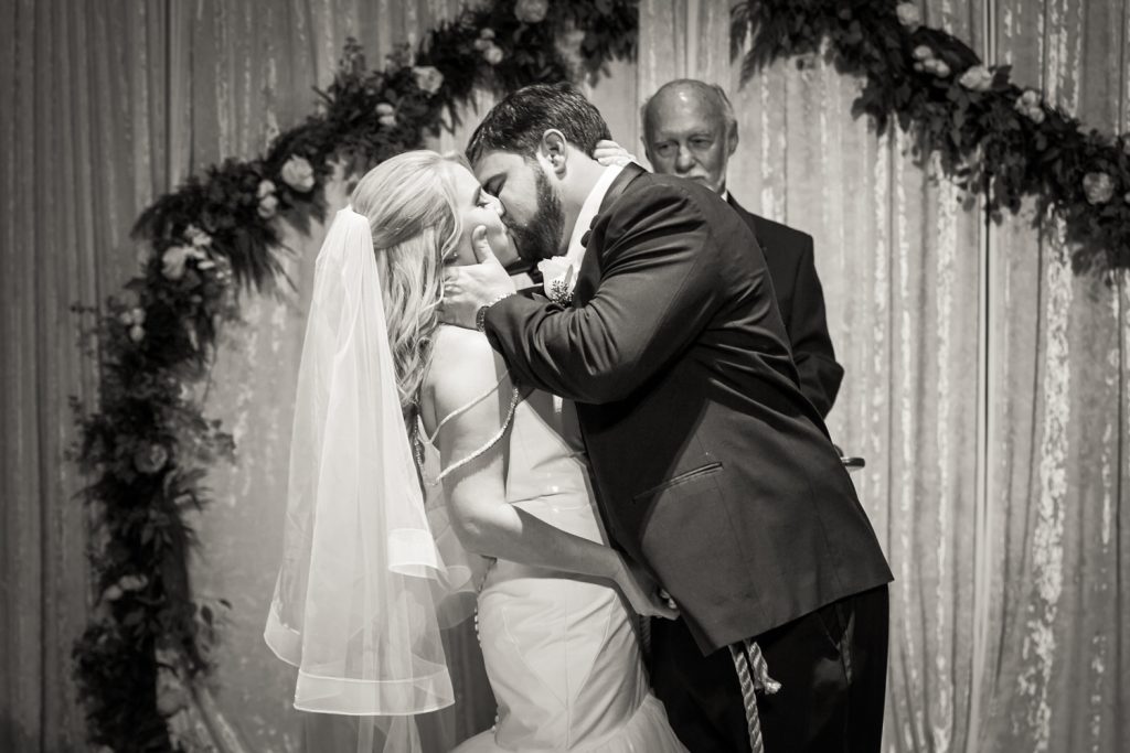 Black and white photo of groom kissing bride at a West Palm Beach wedding