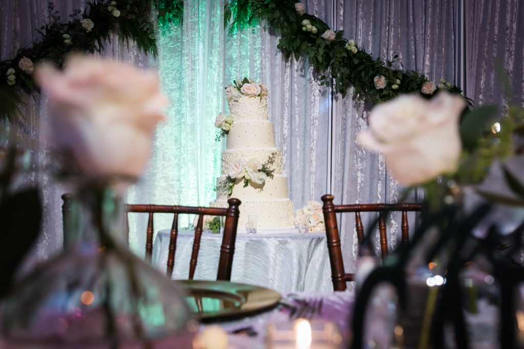 View of wedding cake through table setting