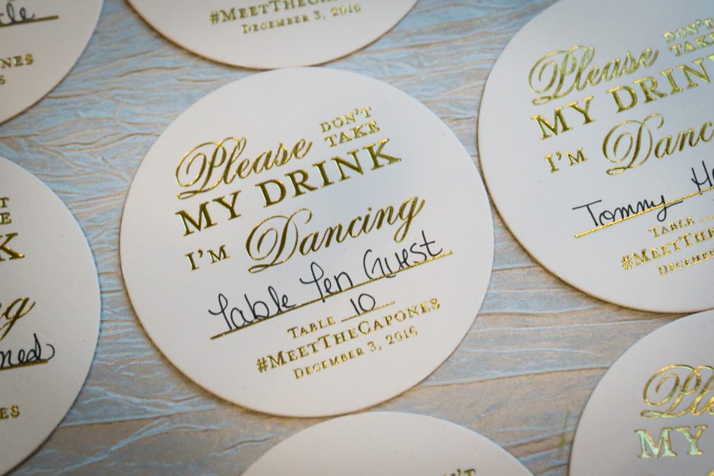 Round 'Please don't take my drink' sign with guest table information