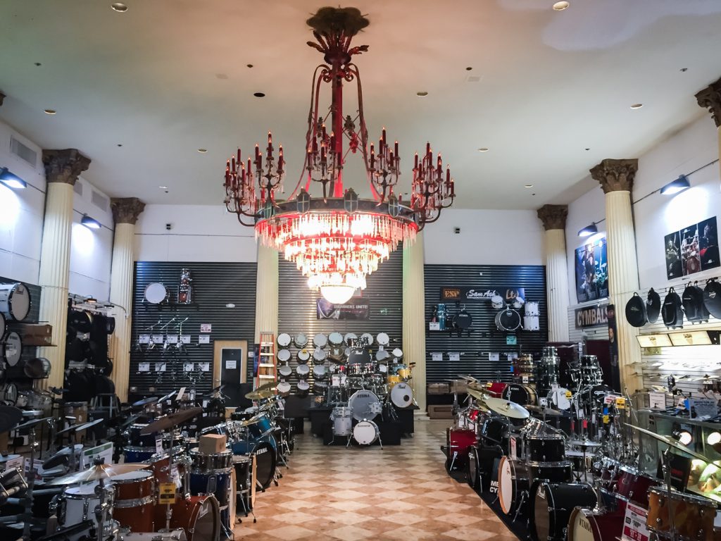 Chandelier and music equipment in the former Kapok Tree Restaurant, now a Sam Ash music store