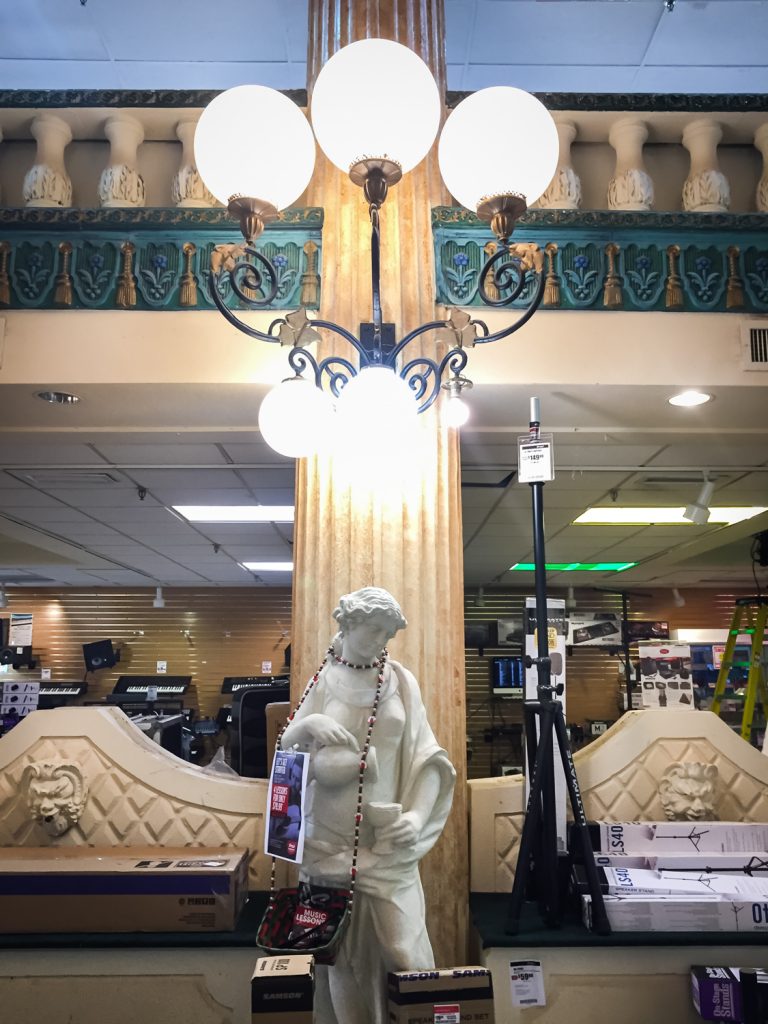 Lamp with statue in the former Kapok Tree Restaurant, now a Sam Ash music store