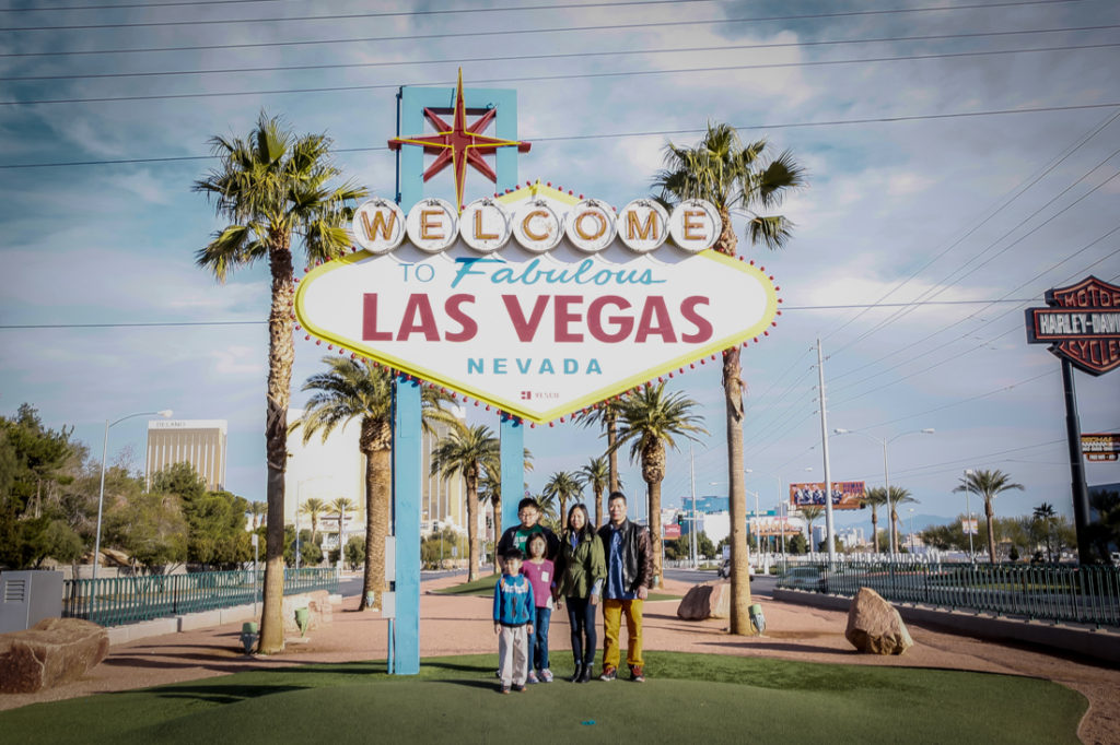 Family in front of the Las Vegas sign