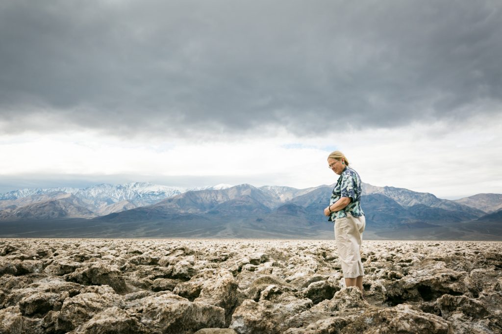 Female tourist looking at rock formations in the Devil's Golf Course in Death Valley National Park