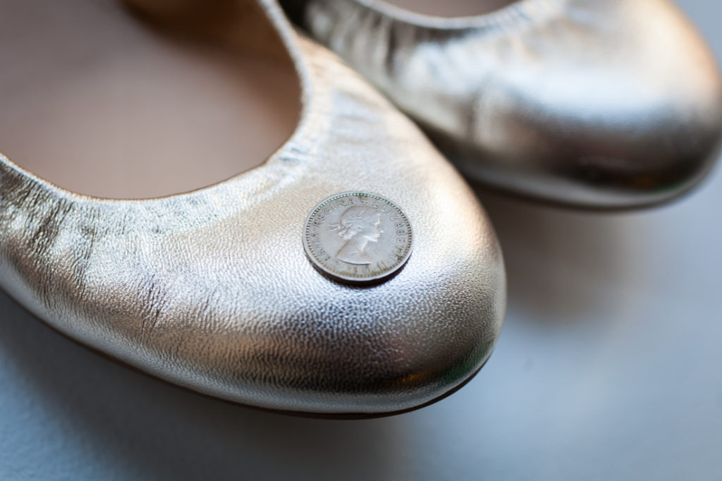Sixpence in a wedding shoe for an article on creative borrowed and blue wedding ideas