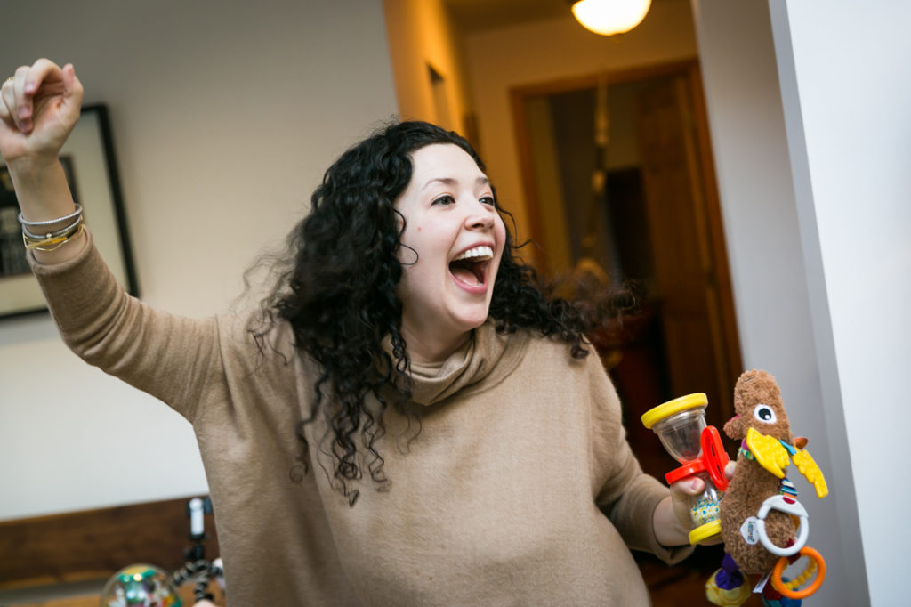 Mother entertaining child for an article on indoor baby portrait tips