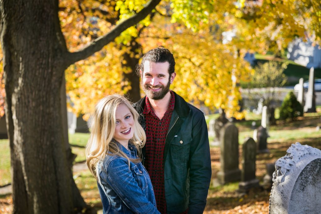 Green-Wood Cemetery engagement photos of couple under tree with yellow leaves