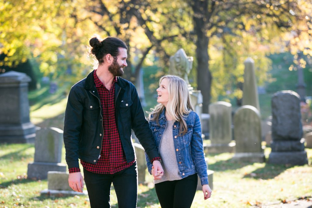 Green-Wood Cemetery engagement photos of couple walking in front of graves