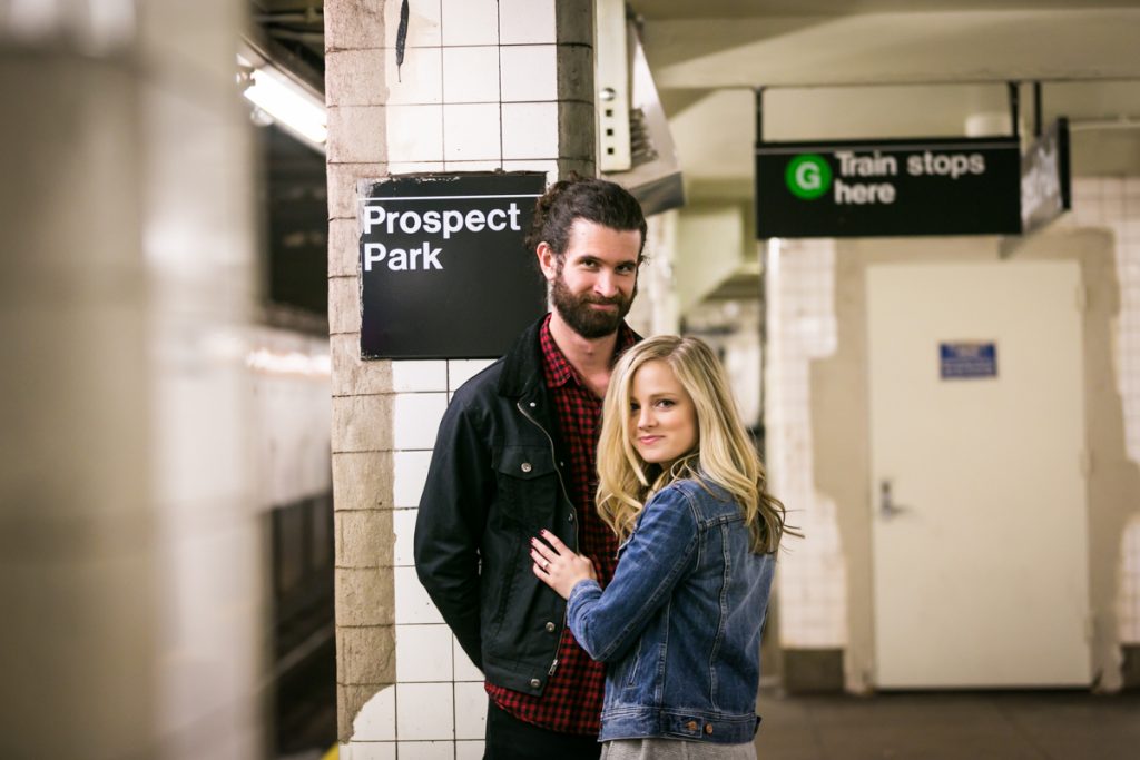 Couple in front of subway station column