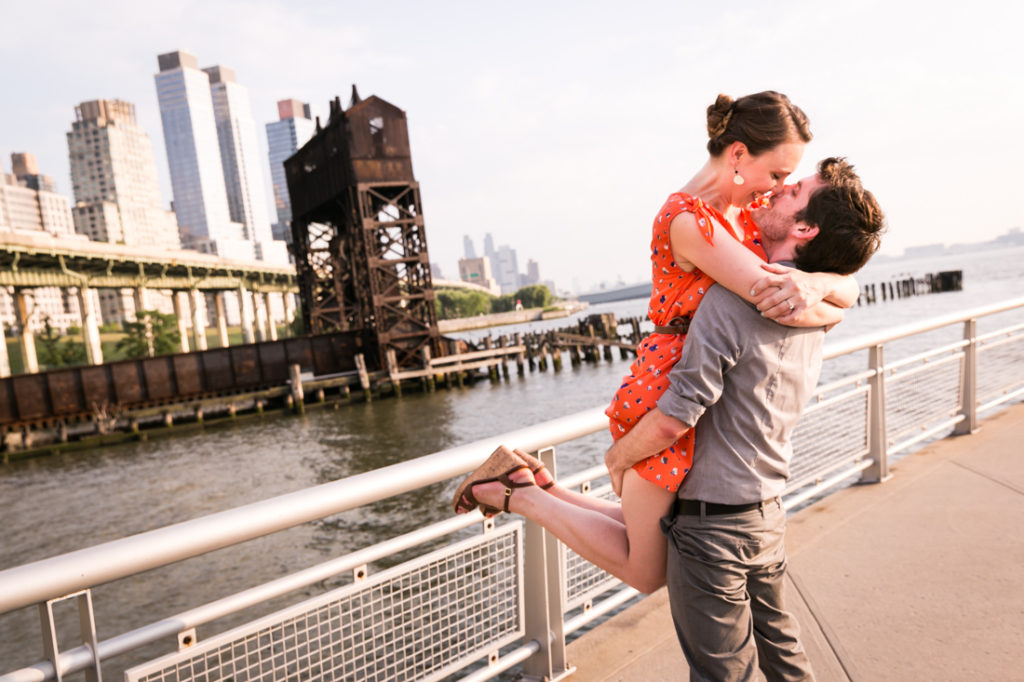 Man lifting up woman for an article on best engagement photos