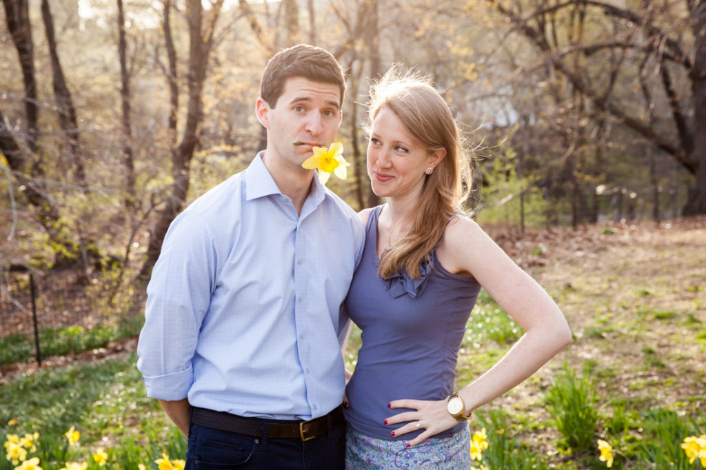 Couple posed with a daffodil for an article on best engagement photos