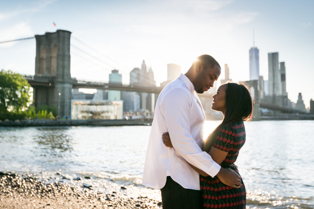 Couple hugging at Brooklyn Bridge Park for an article on best engagement photos
