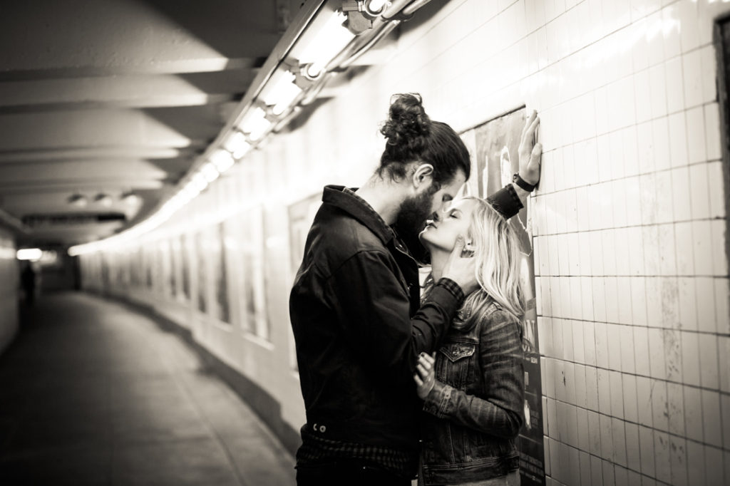 Couple kissing in the subway for an article on best engagement photos